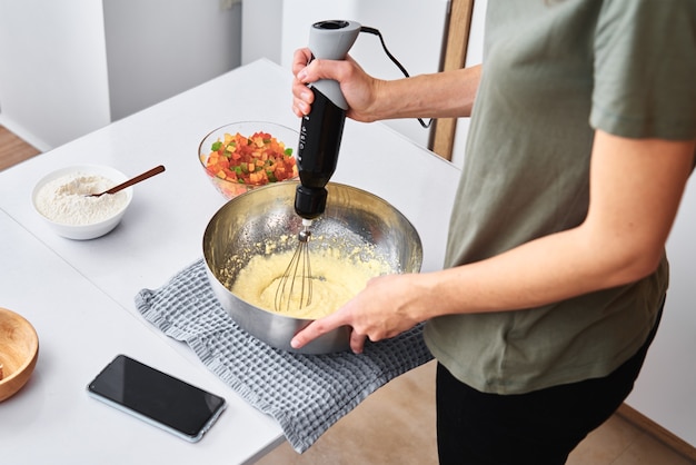 Woman in the kitchen cooking a cake.