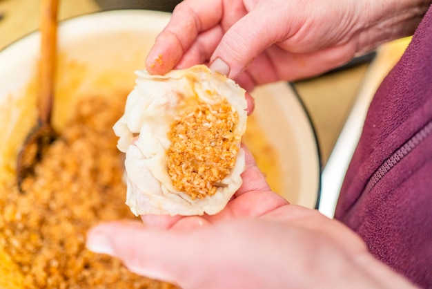 A woman in the kitchen prepares a dish of Golubtsi