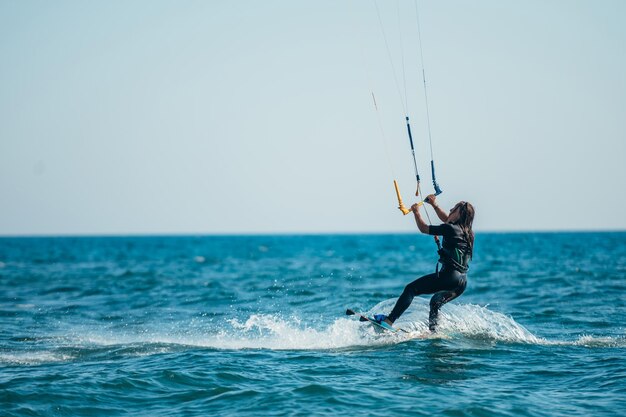 海でカイトサーフィンをする女性