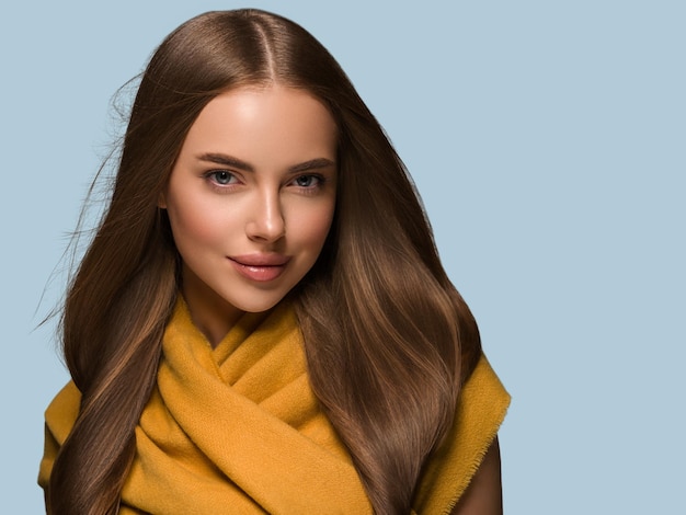 Woman in knit clothes yellow autumn winter style long hair. Color background blue