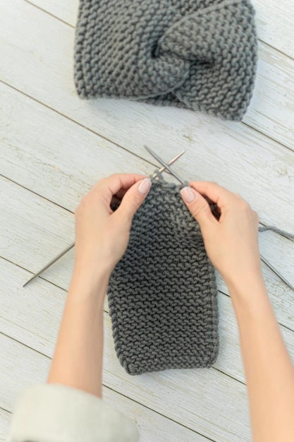 a woman knits a wool product