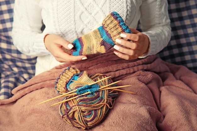 Woman knitting small socks