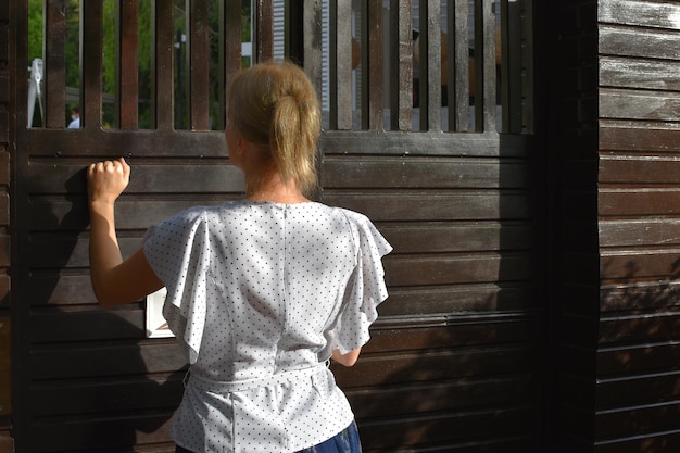 woman knocking on the outside door go outside to the garden