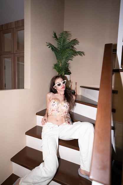 Photo woman in lace corset sitting on indoor stairs