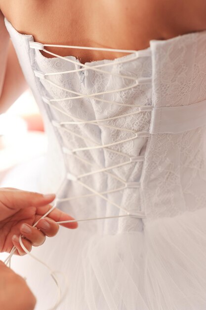 Woman lace wedding dress back close up. Celebration.