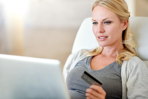 Woman laptop and credit card for ecommerce payment or electronic purchase in living room at home Female person or shopper on computer for online shopping bank app or internet banking at the house