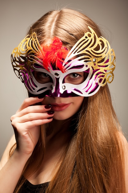 Woman in large multicolored carnival mask