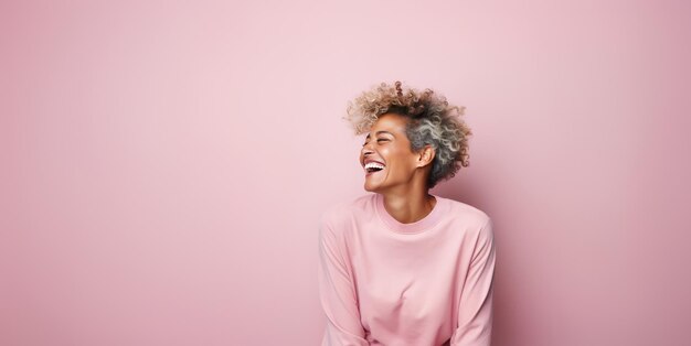 Woman laughing on isolated pink background