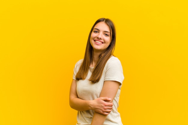 woman laughing shyly and cheerfully, with a friendly and positive but insecure attitude