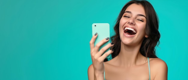 Woman laughs holds cell phone joyful