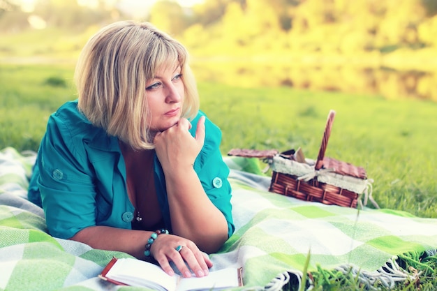 Woman lay and read book sun