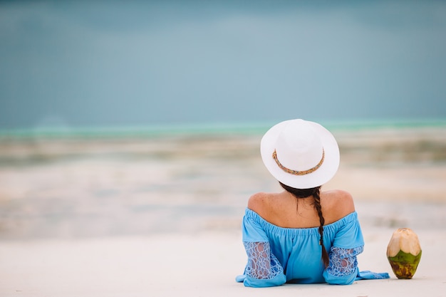 Woman laying on the beach enjoying summer holidays looking at the sea