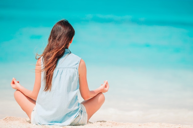 Woman laying on the beach enjoying summer holidays looking at the sea