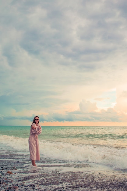 Woman laying on the beach enjoying summer holidays looking at the sea