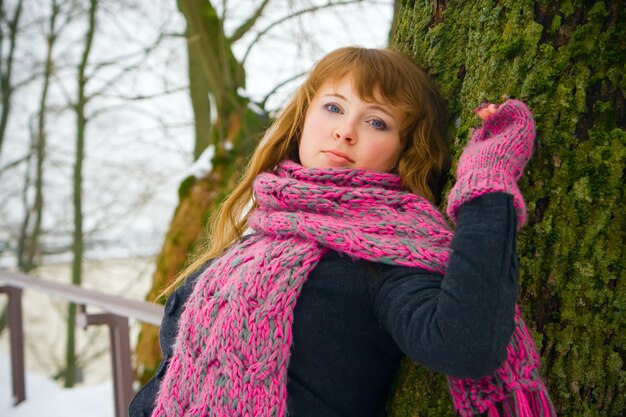 Woman Leaning Against a Tree