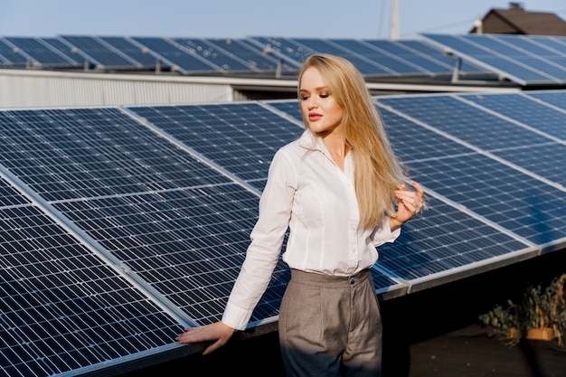 Woman leans on solar panels