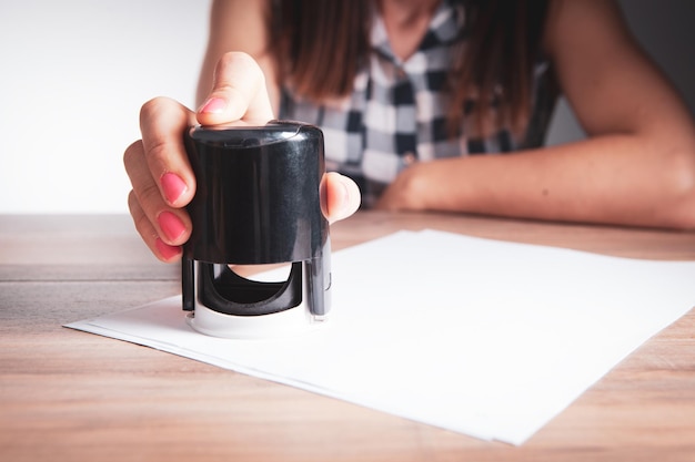 Woman leaves stamp on paper