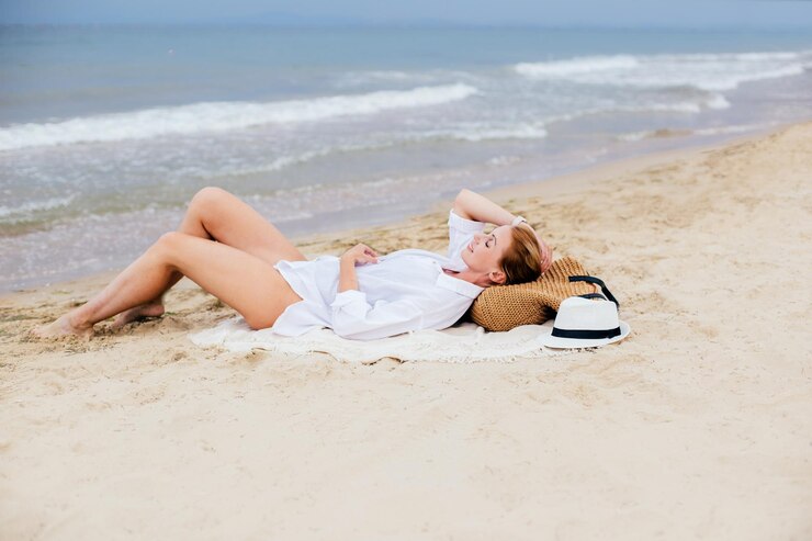 woman lies on the beach on the sand at the seashore