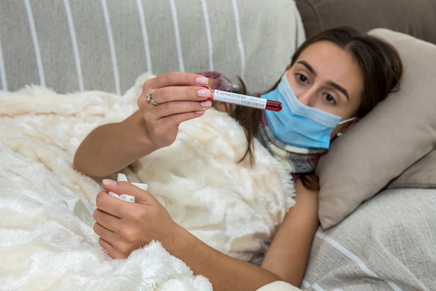 woman lies at home on the couch and looks at the whole result