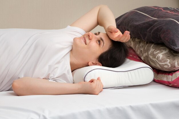 A woman lies on an orthopedic pillow