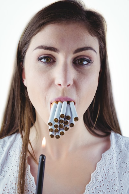 Woman lighting many cigarettes in mouth