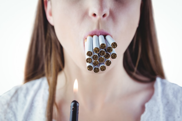 Woman lighting many cigarettes in mouth