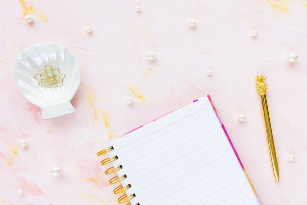 Woman to do list and pen on pink background