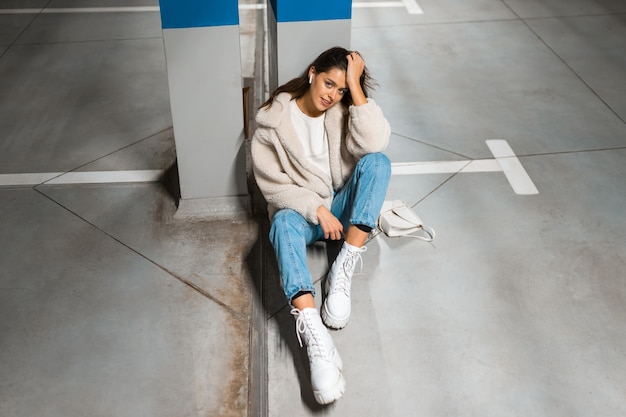 Woman listen to music in underground parking