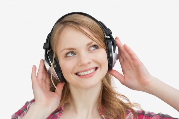 Woman listening music against a white background
