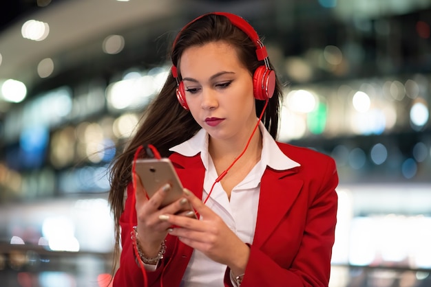 Woman listening music from her mobile phone