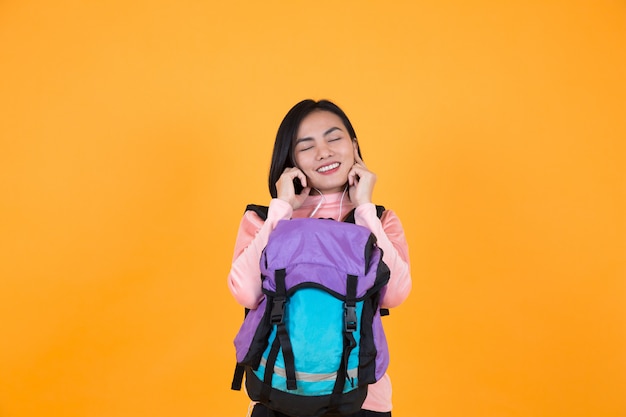 Woman listening to music and schoolbag