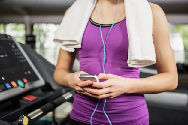 Woman listening to music on treadmill