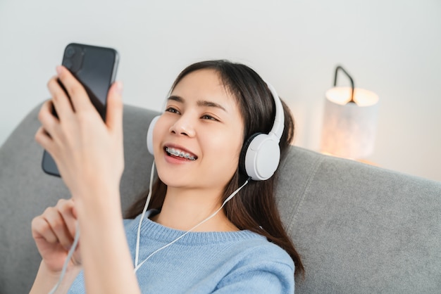 Woman listening to music with white headphones