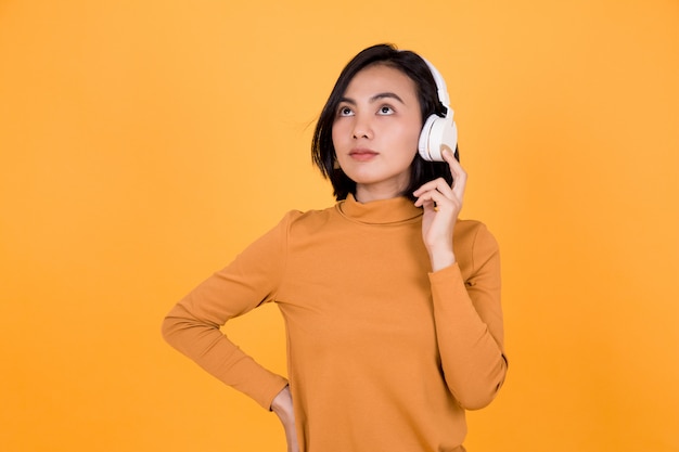 Woman listening to music with white headphones