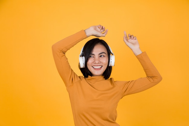 Woman listening to music with white headphones