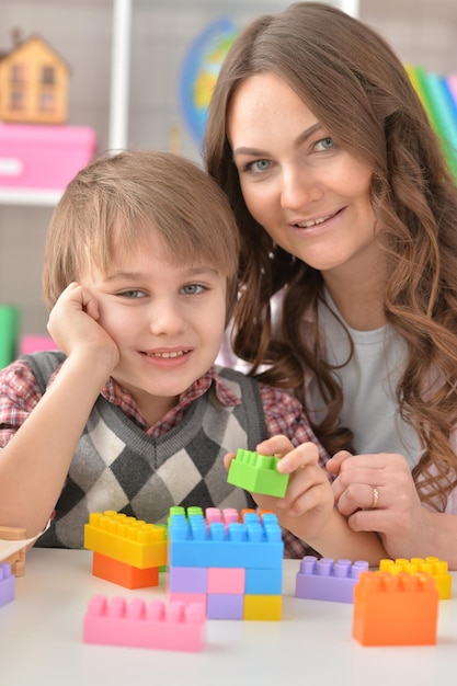 Woman and little boy playing game together