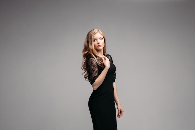 Woman in long black dress posing  