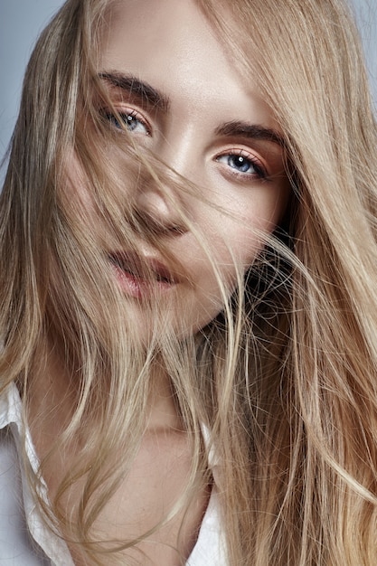 Woman long hair blonde waving in the wind