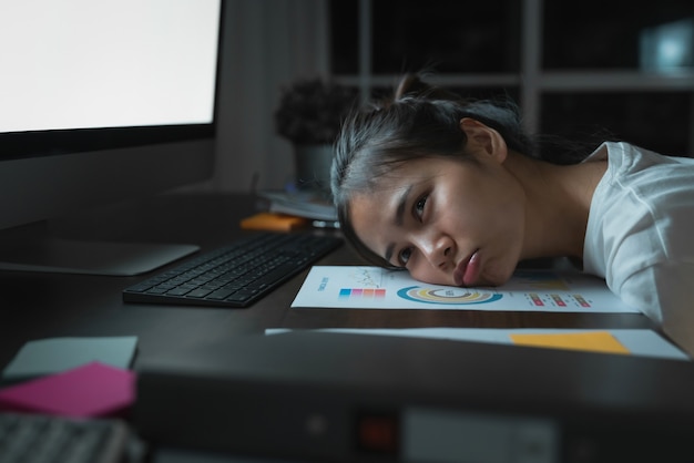 woman look at the computer screen on office at night.