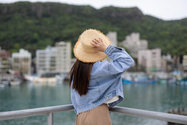 台湾のヨリウ港湾の埠頭を見る女性