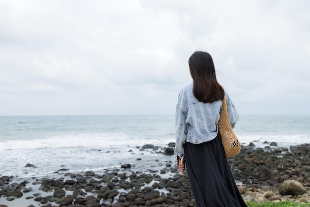 Woman look at the sea at bad fog weather