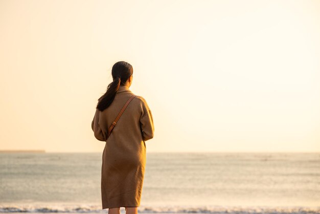 Woman look at the sea in the sunset time