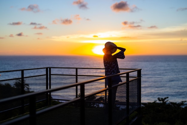 Woman look at the sunset in balcony