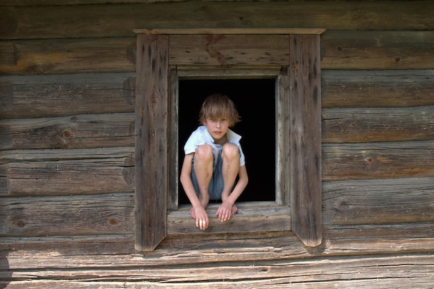 woman looking away while sitting on wooden hut