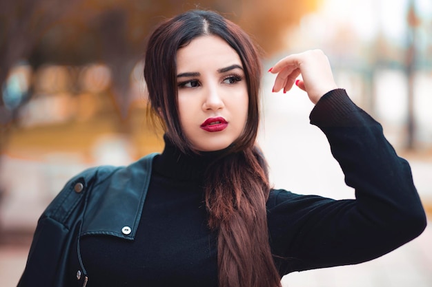 Woman looking away while standing outdoors