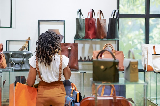 Woman looking at bag on shelves