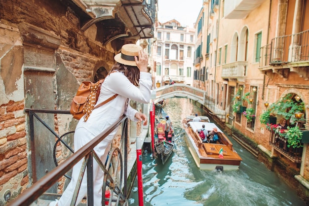 Woman looking at canal with gandola