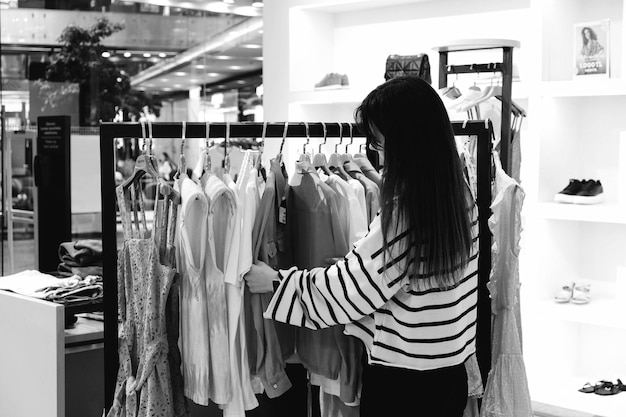 woman looking at clothes and shopping in mall