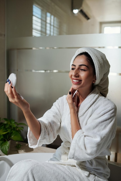 Woman Looking at Compact Mirror