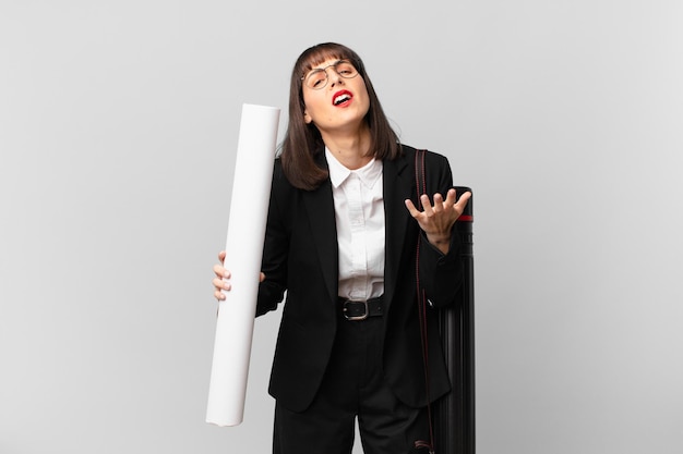 Woman looking desperate and frustrated, stressed, unhappy and annoyed, shouting and screaming